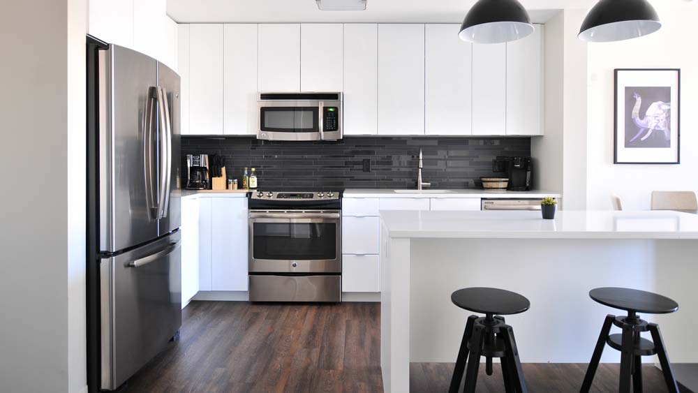 A clean, modern kitchen with an array of home appliances